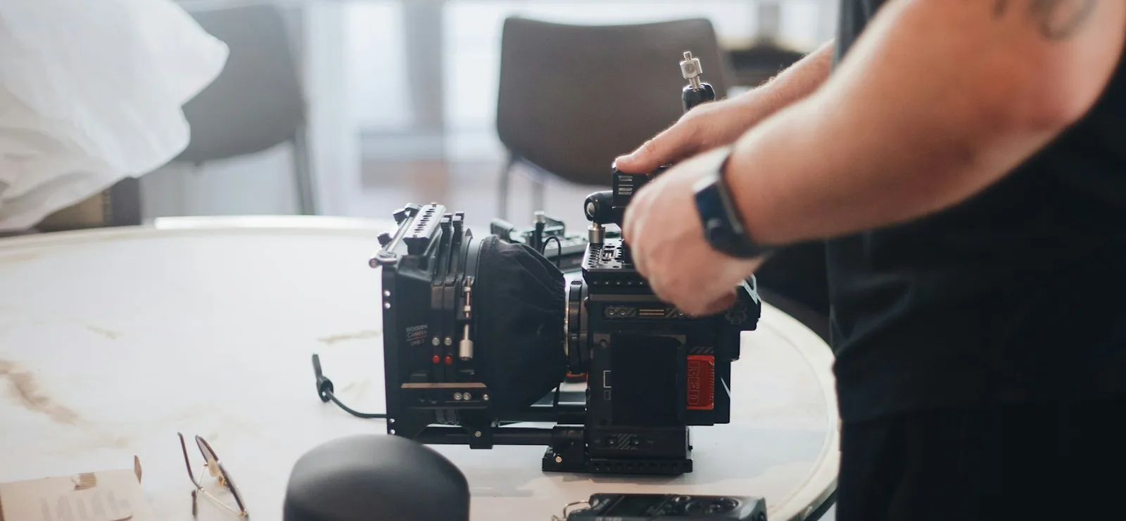 Camera operator adjusting a professional cinema camera rig